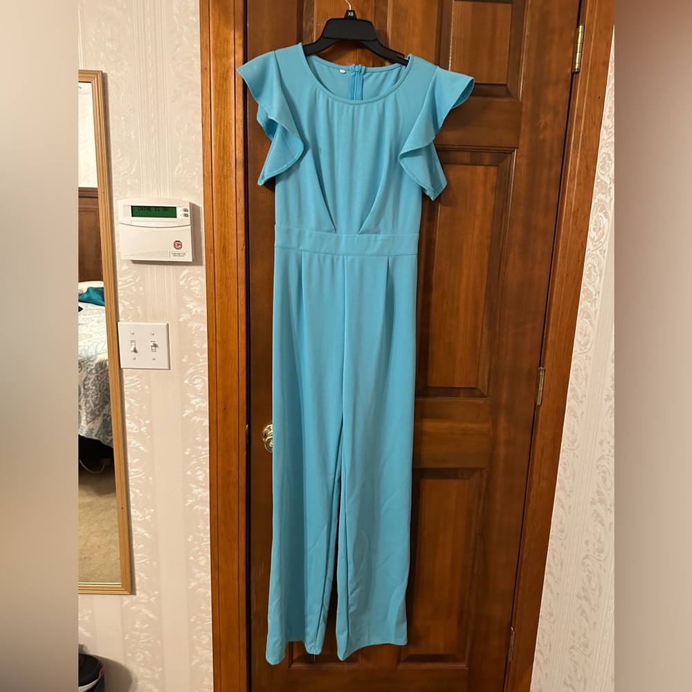 New, never worn, no tags, aqua jumpsuit with ruffle sleeves
